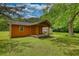 View of outbuilding in the spacious yard, with porch and a swing at 123 Nelson Street, Newborn, GA 30056
