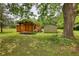 Quaint outbuilding with a porch, paired with a storage shed in the spacious backyard at 123 Nelson Street, Newborn, GA 30056