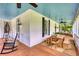 Charming wrap around porch with ceiling fans, seating areas, dining table and wooden floors at 123 Nelson Street, Newborn, GA 30056