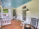 Spacious porch with rocking chairs and ceiling fan, ideal for relaxing outdoors at 123 Nelson Street, Newborn, GA 30056