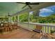 Relaxing porch features ample seating and overlooks a manicured yard with white picket fence at 123 Nelson Street, Newborn, GA 30056