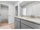 Bright bathroom featuring a double vanity with granite countertop and modern fixtures at 1707 Bouquet Way, Mcdonough, GA 30253