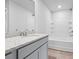 Bright bathroom featuring granite countertops, modern fixtures, and a shower over a soaking tub at 1707 Bouquet Way, Mcdonough, GA 30253