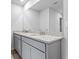 Bright bathroom featuring a double vanity with granite countertop and modern fixtures at 1707 Bouquet Way, Mcdonough, GA 30253