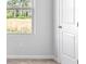 Bedroom features a window to the outside, a white door, and neutral walls at 1707 Bouquet Way, Mcdonough, GA 30253