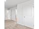 Bedroom with neutral carpet, open doors, and white trim at 1707 Bouquet Way, Mcdonough, GA 30253