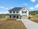 Two-story home with covered entry, gray roof, two-car garage, and neutral siding at 1707 Bouquet Way, Mcdonough, GA 30253
