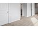 Hallway with neutral plush carpet, and access to rooms with paneled doors at 1707 Bouquet Way, Mcdonough, GA 30253