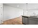 Kitchen featuring stainless steel dishwasher, gray cabinets, tile back splash and hard wood floors at 1707 Bouquet Way, Mcdonough, GA 30253