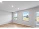 Open living area featuring hardwood floors, many windows, and a glass door for backyard access at 1707 Bouquet Way, Mcdonough, GA 30253