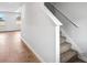 Carpeted stairs with white railing and baseboard next to beautiful hard wood floor at 1707 Bouquet Way, Mcdonough, GA 30253