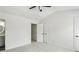 Well-lit bedroom with neutral carpet, ceiling fan and ensuite bathroom at 216 Buckland Dr, Alpharetta, GA 30022