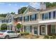 Inviting townhouse showcases classic architecture with neat landscaping, enhancing its curb appeal in a suburban setting at 216 Buckland Dr, Alpharetta, GA 30022