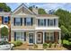 Charming townhouse featuring a well-maintained facade, complemented by neat landscaping and a cozy covered entrance at 216 Buckland Dr, Alpharetta, GA 30022