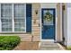 Welcoming front entrance featuring a stylish blue door, adorned with a floral wreath and a 'Welcome' mat at 216 Buckland Dr, Alpharetta, GA 30022