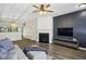 Comfortable living room featuring a fireplace, TV, hardwood floors, and an open layout leading to the kitchen at 216 Buckland Dr, Alpharetta, GA 30022