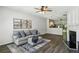 Bright living room featuring hardwood floors, a comfortable gray sofa, and an open layout to the kitchen at 216 Buckland Dr, Alpharetta, GA 30022