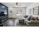 Stylish living room features a dark accent wall, hardwood floors, a modern TV, and a comfortable gray sofa at 216 Buckland Dr, Alpharetta, GA 30022