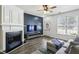 Inviting living area featuring a fireplace, dark accent wall, hardwood flooring, and a clear view to the door at 216 Buckland Dr, Alpharetta, GA 30022