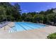 Outdoor pool with lounge chairs and lush landscaping in the background at 216 Buckland Dr, Alpharetta, GA 30022