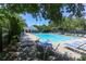 Community pool with lounge chairs, tables, and a covered seating area at 216 Buckland Dr, Alpharetta, GA 30022