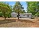 View of the house from backyard featuring a deck with pergola and lots of trees at 3142 Chamblee Gap Rd, Cumming, GA 30040