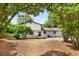 View of the house, deck, and backyard, with a large grassy area beyond the patio at 3142 Chamblee Gap Rd, Cumming, GA 30040