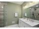 Modern bathroom featuring a double vanity, sleek countertops, large mirrors, and a glass-enclosed shower at 3142 Chamblee Gap Rd, Cumming, GA 30040