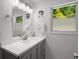 A well lit bathroom features a modern vanity, a large mirror, and stylish fixtures at 3142 Chamblee Gap Rd, Cumming, GA 30040