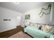 Cozy bedroom with a twin bed, wood flooring, natural light, and an inviting atmosphere with decorations at 3142 Chamblee Gap Rd, Cumming, GA 30040