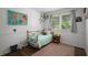 Bright bedroom with a twin bed, wood floors, natural light from the window, and unique decorations for a youthful touch at 3142 Chamblee Gap Rd, Cumming, GA 30040