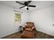Cozy bedroom features a comfortable armchair with ottoman, a window, and hardwood floors at 3142 Chamblee Gap Rd, Cumming, GA 30040