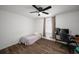 Bright bedroom with hardwood floors, a window, and a modern workspace setup for productivity at 3142 Chamblee Gap Rd, Cumming, GA 30040