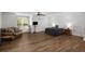 Spacious bedroom area with wood floors, natural light, a comfortable seating area, and ample room for relaxation at 3142 Chamblee Gap Rd, Cumming, GA 30040