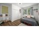 Bedroom with wood floors, closet doors, comfortable bed with decorative pillows, and a bright, airy feel at 3142 Chamblee Gap Rd, Cumming, GA 30040