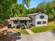 Aerial view of a charming home with white siding, black trim, and a welcoming front porch at 3142 Chamblee Gap Rd, Cumming, GA 30040