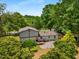 Rear view of the property showcasing the deck and surrounding trees at 3142 Chamblee Gap Rd, Cumming, GA 30040