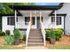Inviting front porch with wooden posts, white railings, and a charming entrance at 3142 Chamblee Gap Rd, Cumming, GA 30040