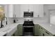 Well-equipped kitchen with stainless steel appliances, white countertops, and ample cabinet space at 3142 Chamblee Gap Rd, Cumming, GA 30040