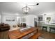 Spacious living room with hardwood floors, a dining table, and modern, open concept kitchen with green cabinets at 3142 Chamblee Gap Rd, Cumming, GA 30040