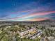 Picturesque aerial view of a well-maintained neighborhood nestled among lush trees and beautiful colorful sky at 5293 Hearthstone St, Stone Mountain, GA 30083