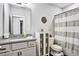 This bathroom features a granite countertop, storage cabinet, and neutral colored shower curtain at 5293 Hearthstone St, Stone Mountain, GA 30083