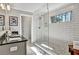 Bathroom featuring a glass-enclosed shower, granite countertops, and a window for natural light at 5293 Hearthstone St, Stone Mountain, GA 30083