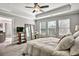 Bedroom with a tray ceiling, a ceiling fan, three windows, and plush carpeting at 5293 Hearthstone St, Stone Mountain, GA 30083