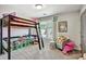 Bright bedroom with a bunk bed, colorful decor, and cozy seating area for play and relaxation at 5293 Hearthstone St, Stone Mountain, GA 30083