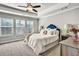 Bedroom with a tray ceiling, a ceiling fan, three windows, and plush carpeting at 5293 Hearthstone St, Stone Mountain, GA 30083