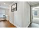 Bright hallway featuring hardwood floors, fresh neutral paint, and an open doorway to the bedroom at 5293 Hearthstone St, Stone Mountain, GA 30083