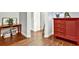 Hallway with decorative cabinet and table, hardwood flooring, and white trim at 5293 Hearthstone St, Stone Mountain, GA 30083