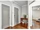 Hallway features hardwood floors and two gray doors, one leading to another room at 5293 Hearthstone St, Stone Mountain, GA 30083