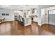 Open kitchen boasts stainless steel appliances, white cabinets, and hardwood floors at 5293 Hearthstone St, Stone Mountain, GA 30083
